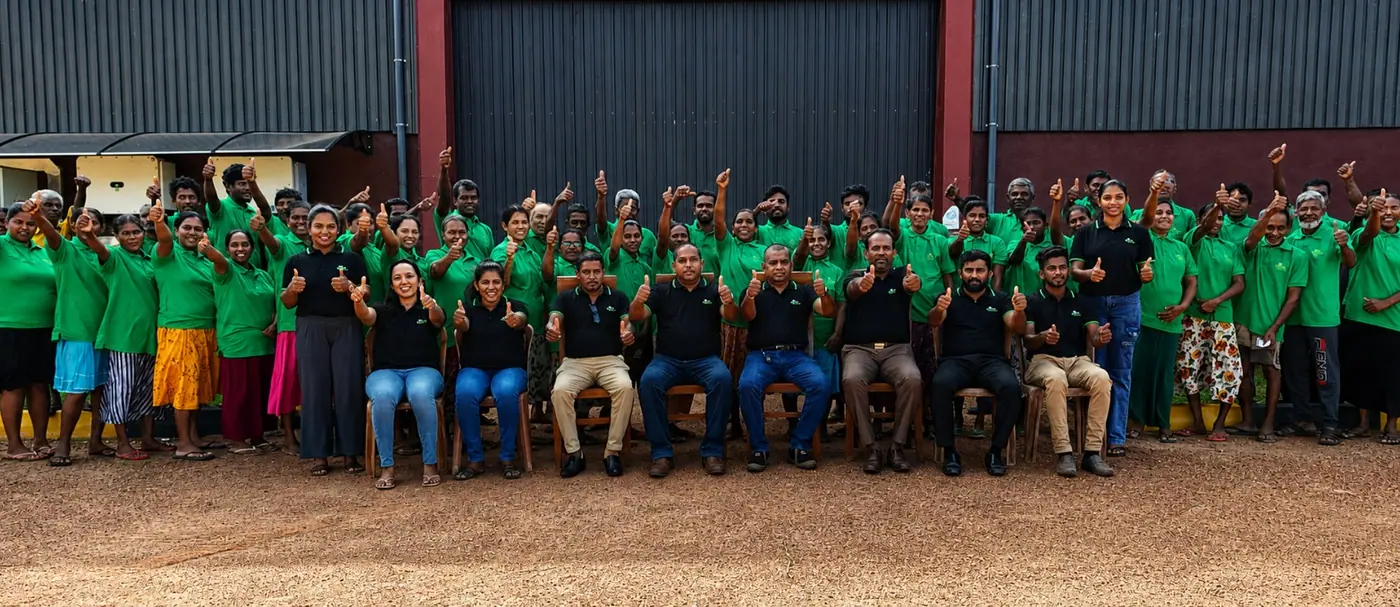 The Go Green Exports workforce photographed together outside the factory building